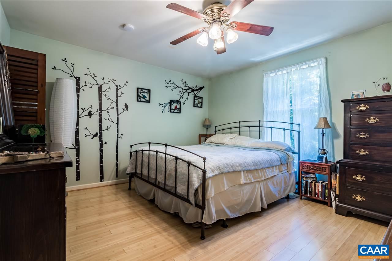 575 Gillums Ridge Road Charlottesville, VA 22903 - Photo 14 of 27 a bedroom with a bed and wooden floor