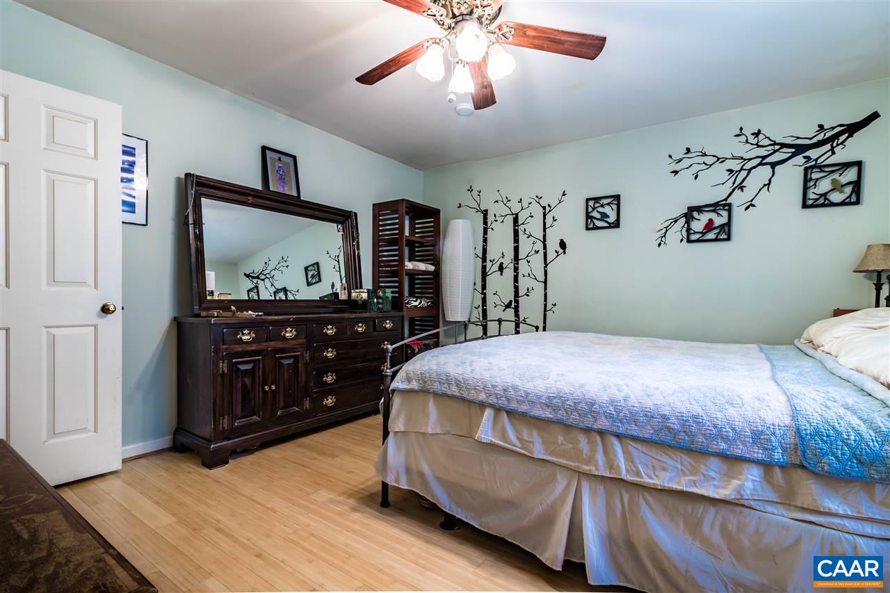 575 Gillums Ridge Road Charlottesville, VA 22903 - Photo 16 of 27 a bedroom with a bed and a mirror on the dresser