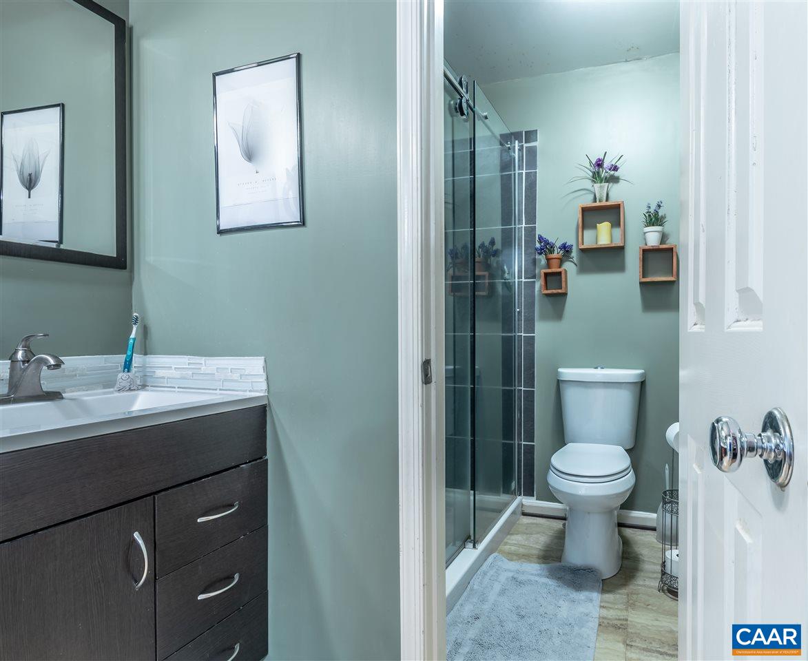 575 Gillums Ridge Road Charlottesville, VA 22903 - Photo 17 of 27 a bathroom with a toilet sink and mirror