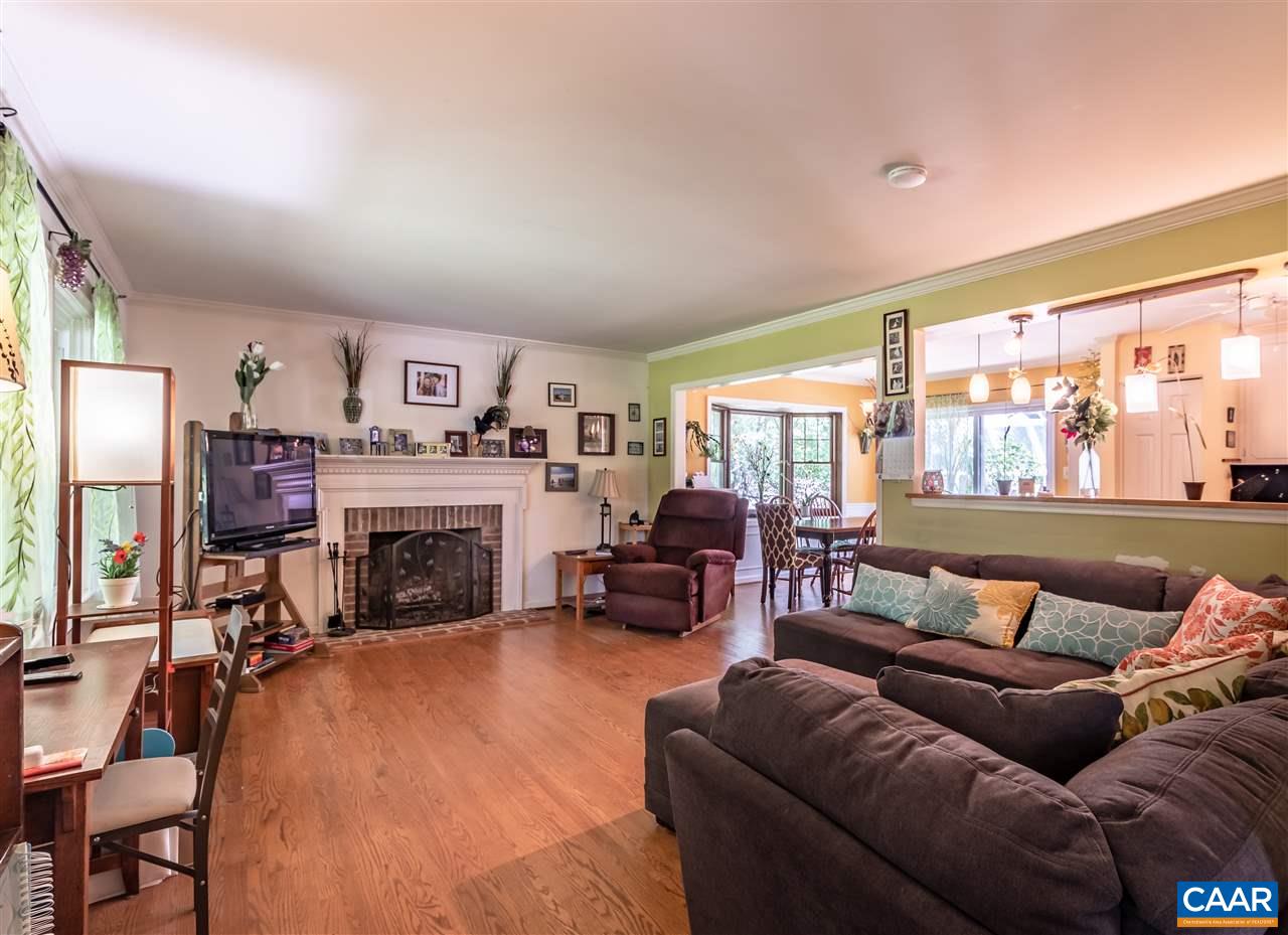 575 Gillums Ridge Road Charlottesville, VA 22903 - Photo 5 of 27 a living room with furniture a large window and a fireplace