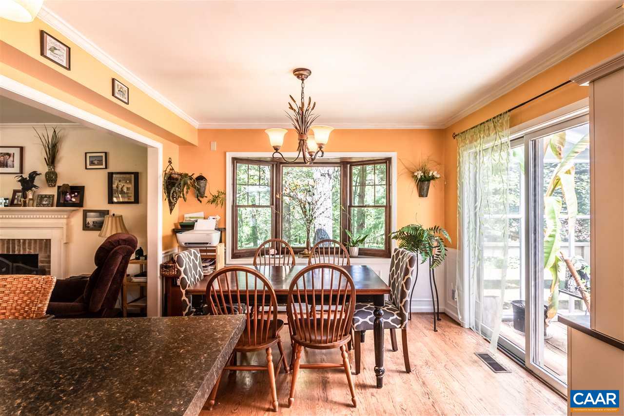 575 Gillums Ridge Road Charlottesville, VA 22903 - Photo 7 of 27 a view of a dining room with furniture large windows and wooden floor