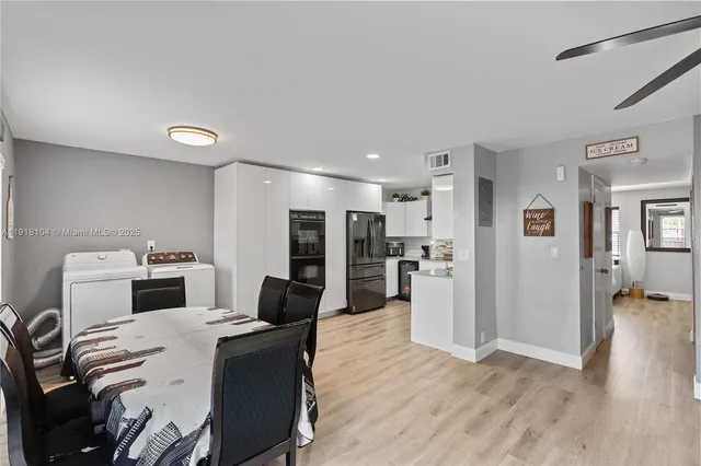 a kitchen with a refrigerator and a stove top oven