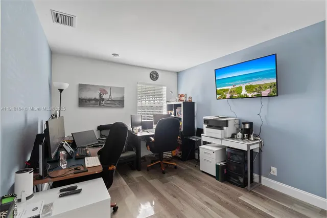 a view of a workspace with furniture and a window