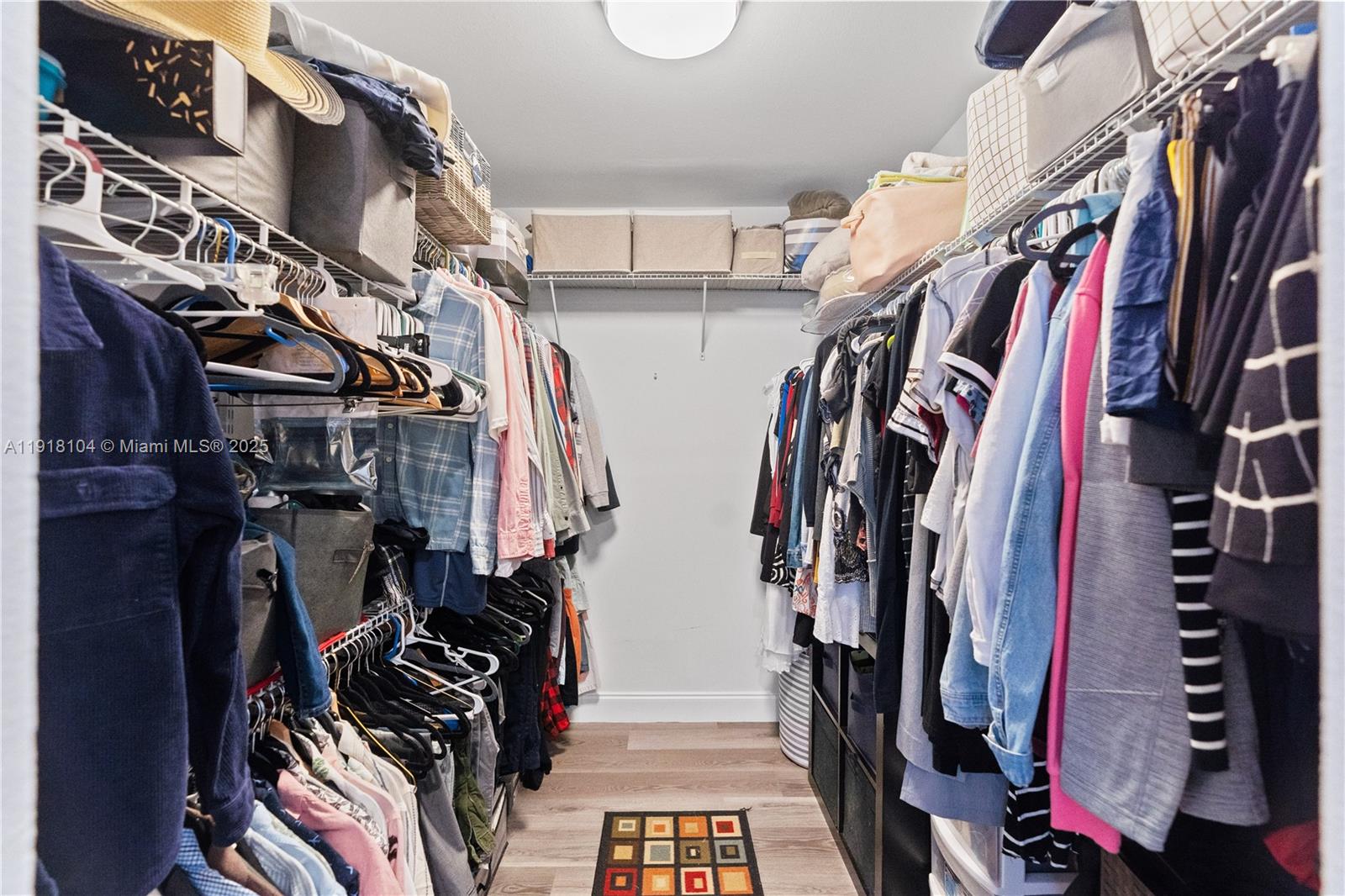 8089 Southwest 18th Court, Unit 27 Davie, FL 33324 - Photo 25 of 36 a view of walk in closet with clothes and shoes