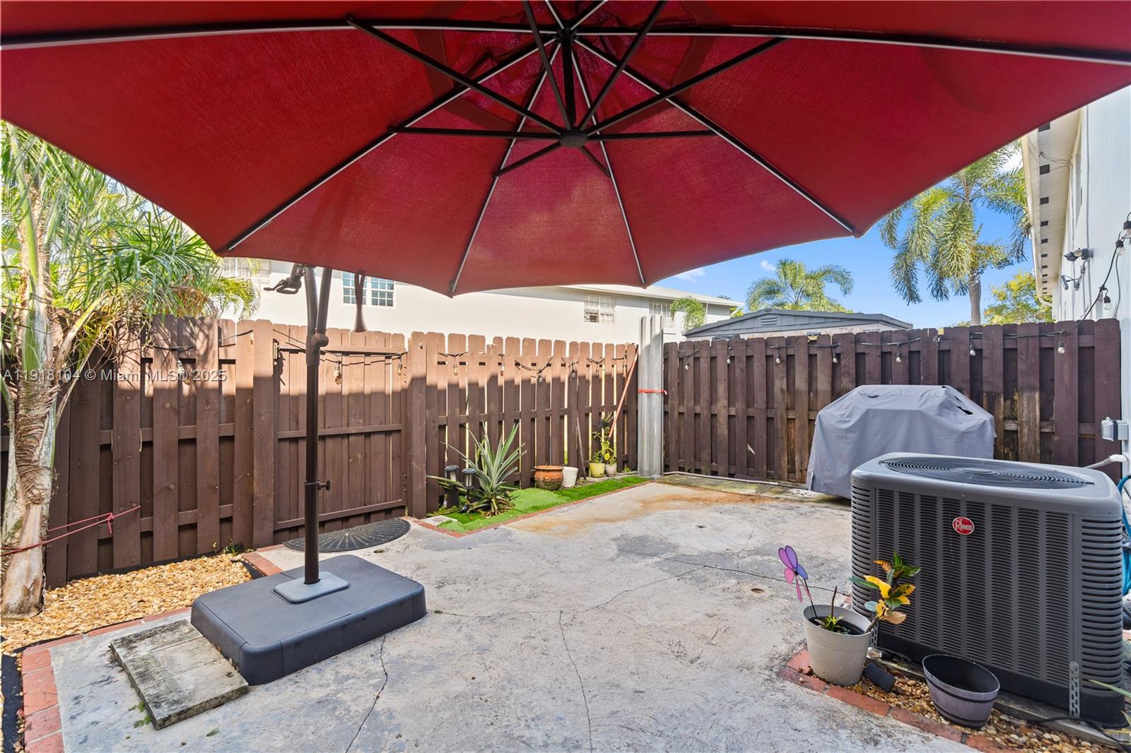 8089 Southwest 18th Court, Unit 27 Davie, FL 33324 - Photo 26 of 36 a view of a patio with a table and chairs under an umbrella