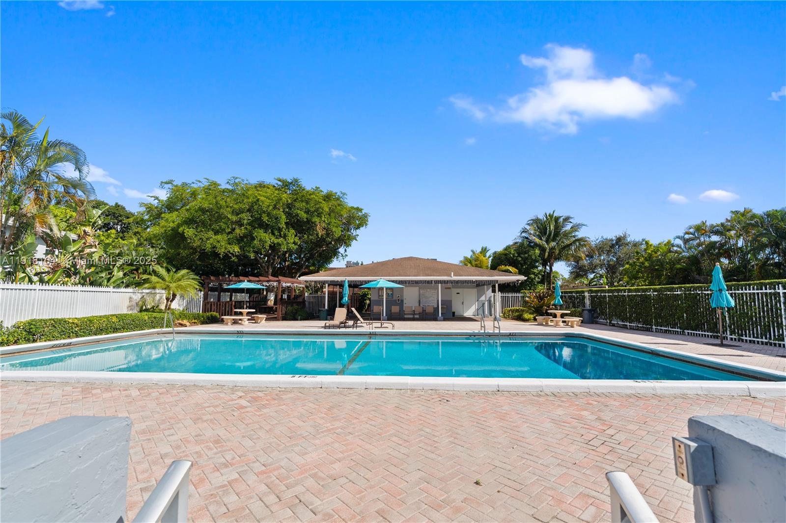 8089 Southwest 18th Court, Unit 27 Davie, FL 33324 - Photo 29 of 36 a view of a swimming pool with an outdoor seating and house in the background