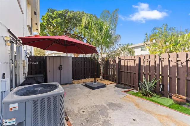a backyard of a house with table and chairs