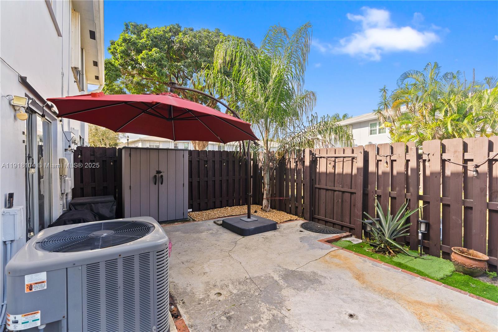 8089 Southwest 18th Court, Unit 27 Davie, FL 33324 - Photo 30 of 36 a backyard of a house with table and chairs