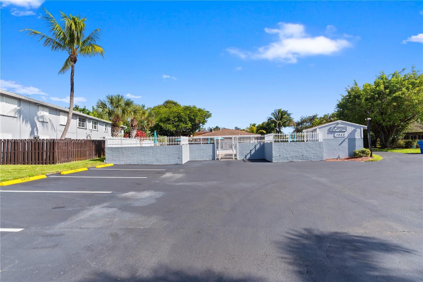 8089 Southwest 18th Court, Unit 27 Davie, FL 33324 - Photo 34 of 36 a view of a swimming pool with a yard and palm trees