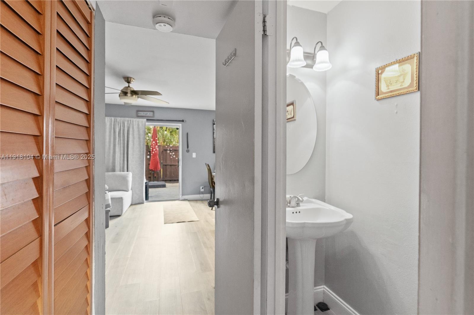 8089 Southwest 18th Court, Unit 27 Davie, FL 33324 - Photo 5 of 36 a bathroom with a sink vanity and a mirror