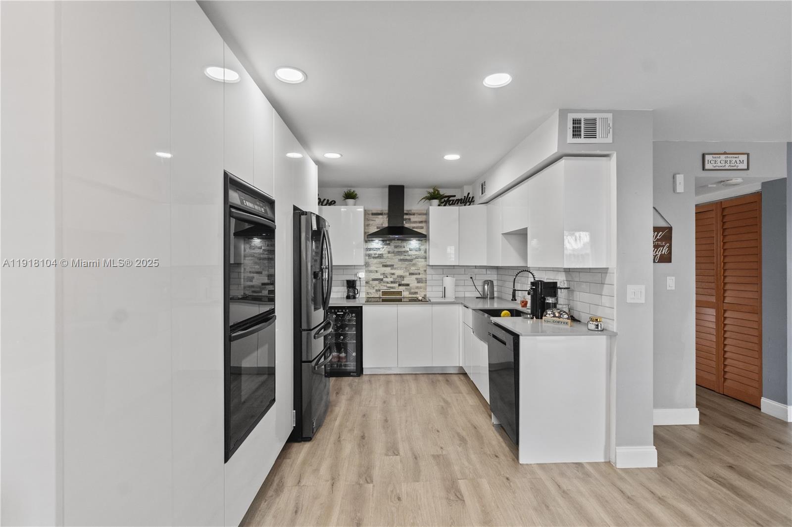 8089 Southwest 18th Court, Unit 27 Davie, FL 33324 - Photo 8 of 36 a kitchen with granite countertop a refrigerator and a stove top oven