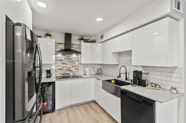 a kitchen with stainless steel appliances a sink stove refrigerator and cabinets