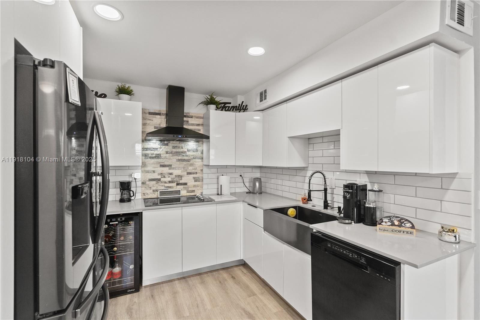 8089 Southwest 18th Court, Unit 27 Davie, FL 33324 - Photo 9 of 36 a kitchen with stainless steel appliances a sink stove refrigerator and cabinets