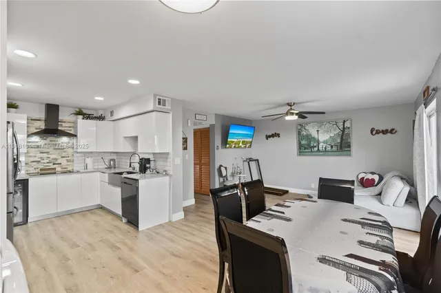 a large white kitchen with cabinets
