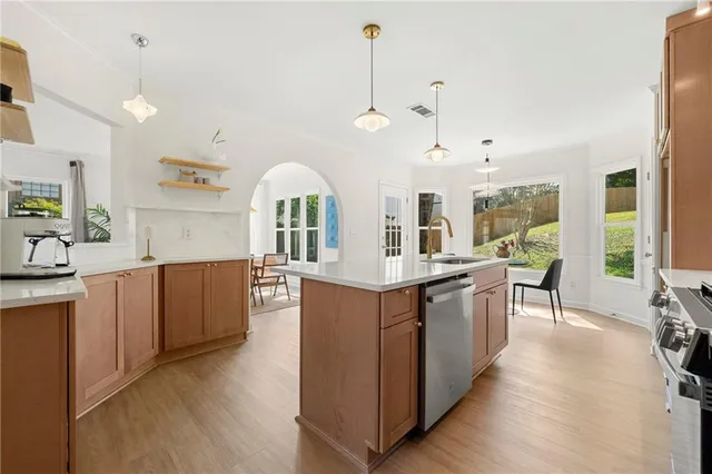 a large kitchen with kitchen island a large counter space and stainless steel appliances