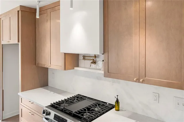 a kitchen with a stove and a refrigerator