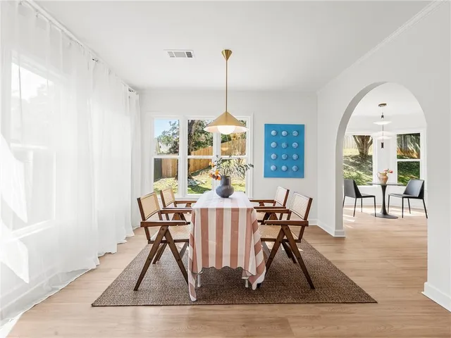 a view of a dining room with furniture window and wooden floor