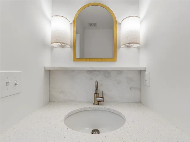 a bathroom with a sink and mirror