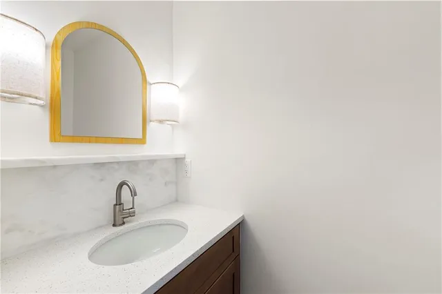 a bathroom with a sink and a mirror