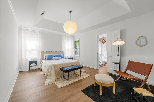 a bedroom with a bed and a chandelier