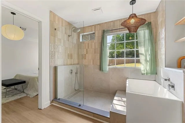 a bathroom with a tub and a shower