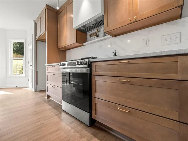 a stove top oven sitting inside of a kitchen
