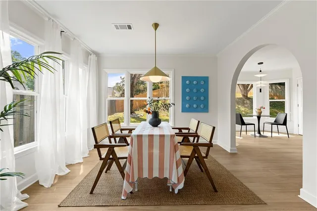 a view of a dining room with furniture and wooden floor