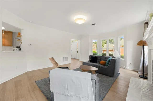 a living room with furniture a large window and a flat screen tv