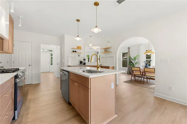 a kitchen with a stove and a wooden floors