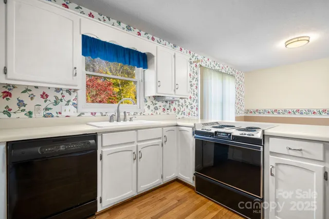 a kitchen with a stove oven and sink