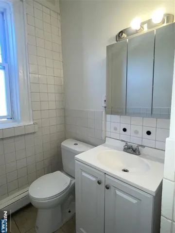 a bathroom with a sink a toilet and mirror