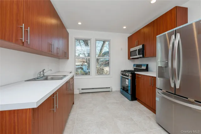 a kitchen with stainless steel appliances granite countertop a refrigerator a sink a stove a microwave and island