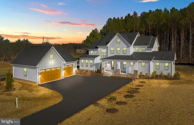 a view of a big house with a big yard and large trees