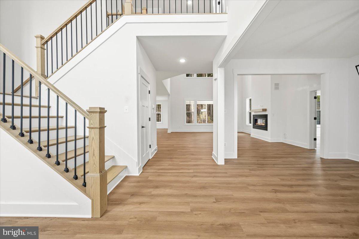 39762 Rivers Edge Lane Lovettsville, VA 20180 - Photo 11 of 118 a view of staircase with lots of frames on wall and wooden floor
