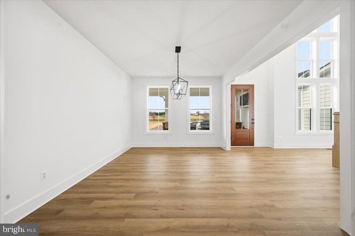39762 Rivers Edge Lane Lovettsville, VA 20180 - Photo 21 of 118 a view of an empty room with window and wooden floor
