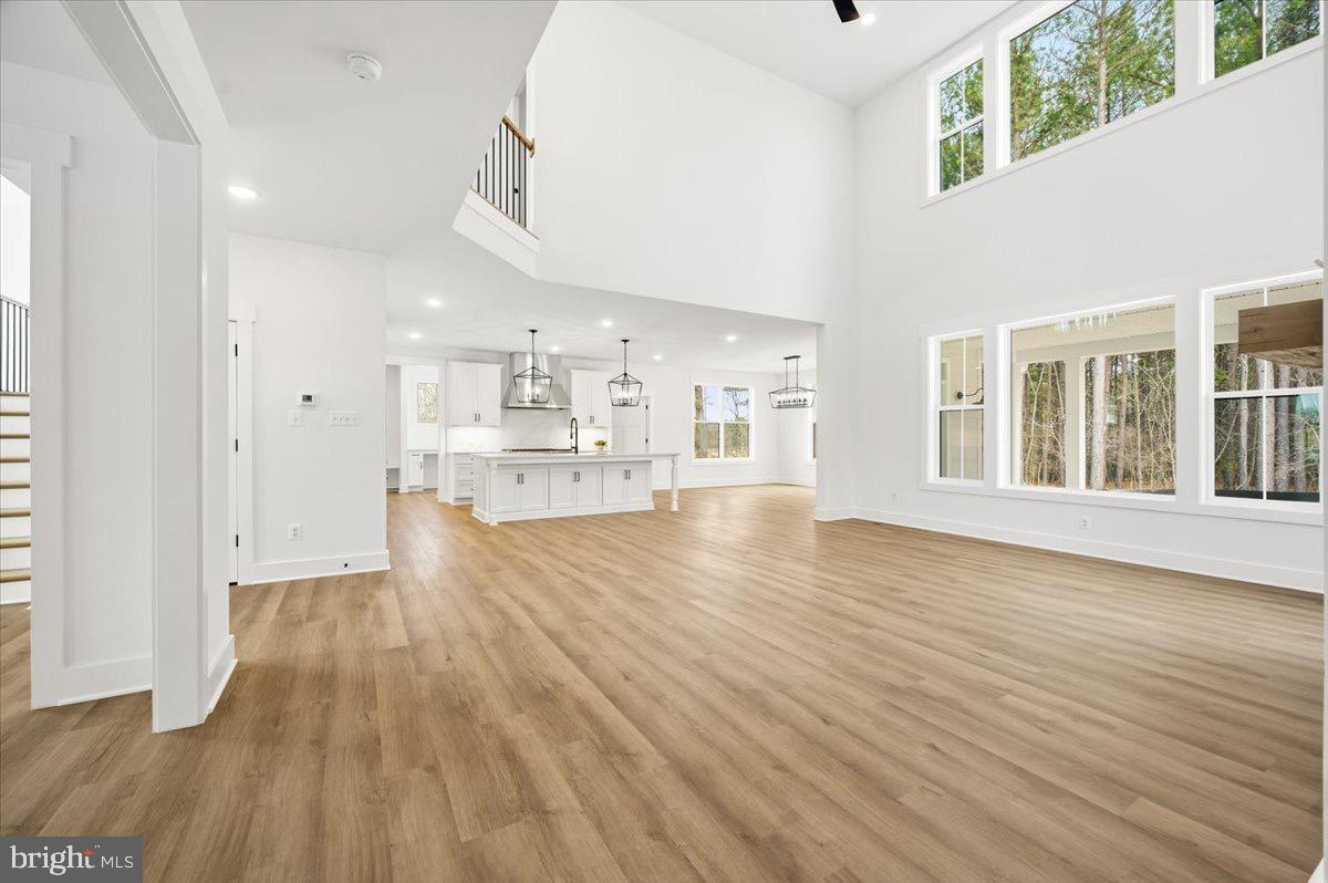 39762 Rivers Edge Lane Lovettsville, VA 20180 - Photo 22 of 118 a view of empty room with wooden floor and windows