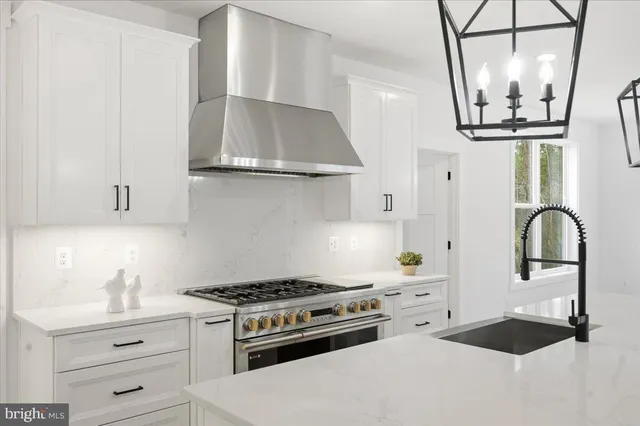a bathroom with a sink and mirror with bathtub
