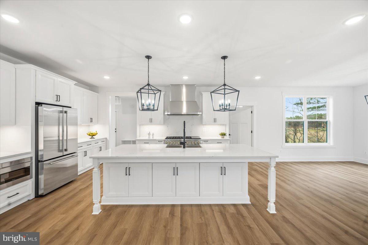 39762 Rivers Edge Lane Lovettsville, VA 20180 - Photo 33 of 118 a kitchen with stainless steel appliances granite countertop a sink cabinets and wooden floor