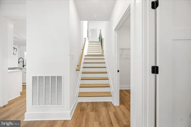 a view of house with yard and sitting area