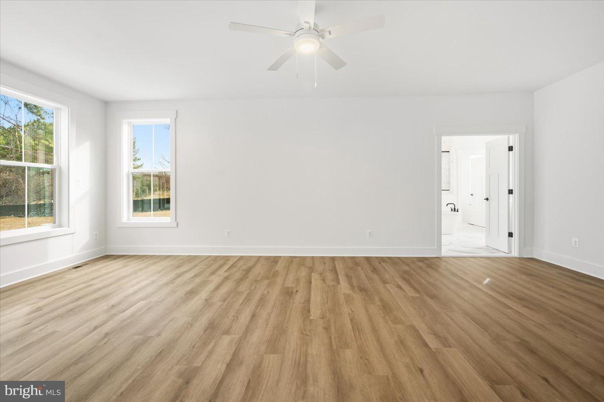 39762 Rivers Edge Lane Lovettsville, VA 20180 - Photo 56 of 118 a view of an empty room with wooden floor and a window