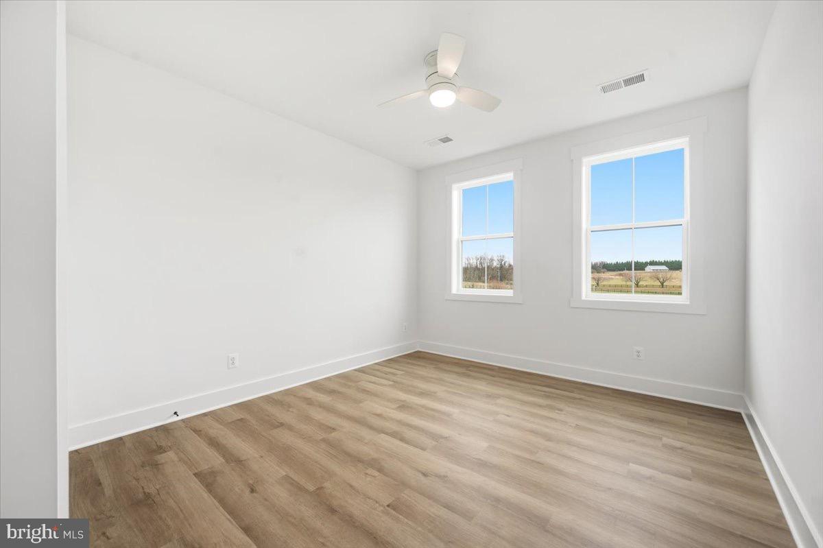 39762 Rivers Edge Lane Lovettsville, VA 20180 - Photo 77 of 118 an empty room with wooden floor chandelier fan and windows
