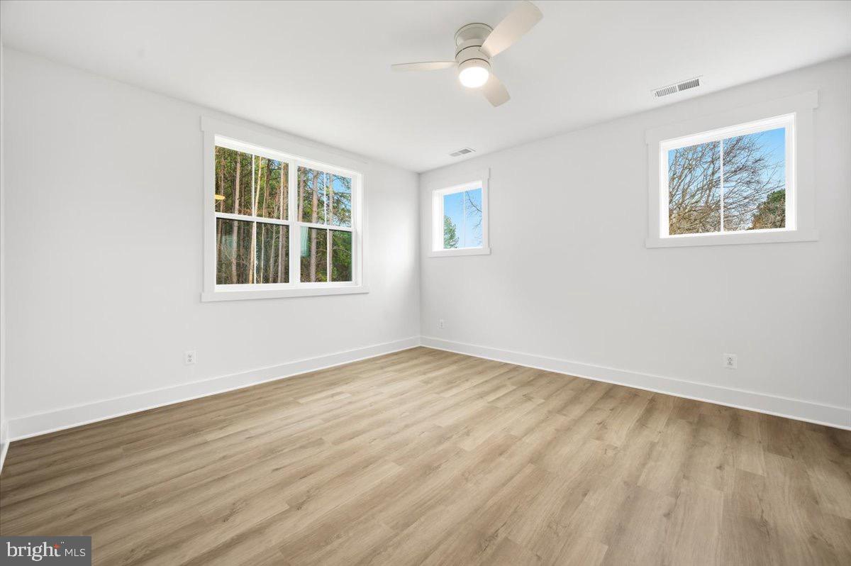 39762 Rivers Edge Lane Lovettsville, VA 20180 - Photo 85 of 118 a view of an empty room with wooden floor and a window