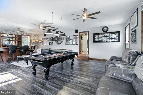 a bedroom with a bed and dresser with mirror