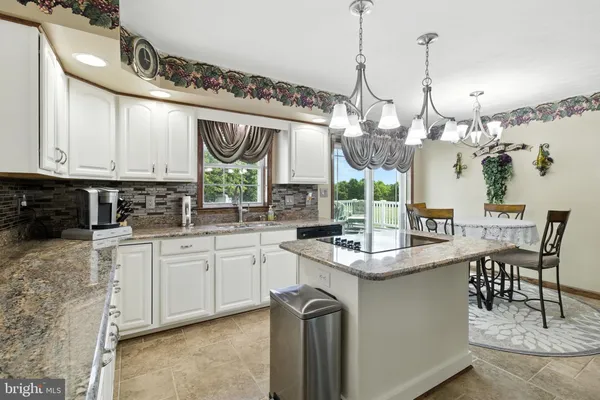 a living room with furniture and view of kitchen