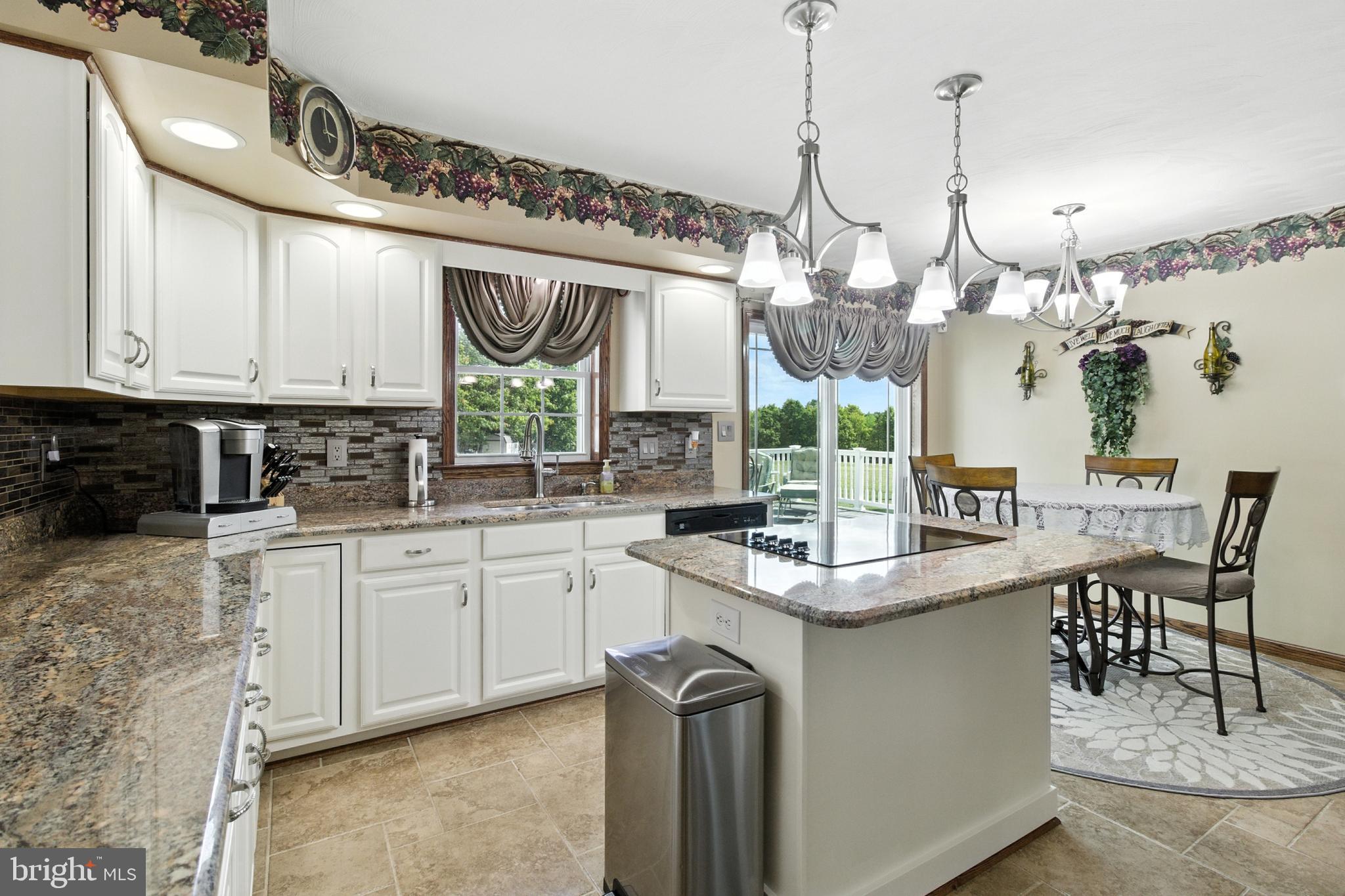 2230 Six Mile Road Philipsburg, PA 16866 - Photo 41 of 70 a kitchen with stainless steel appliances granite countertop a sink a stove and a wooden floor