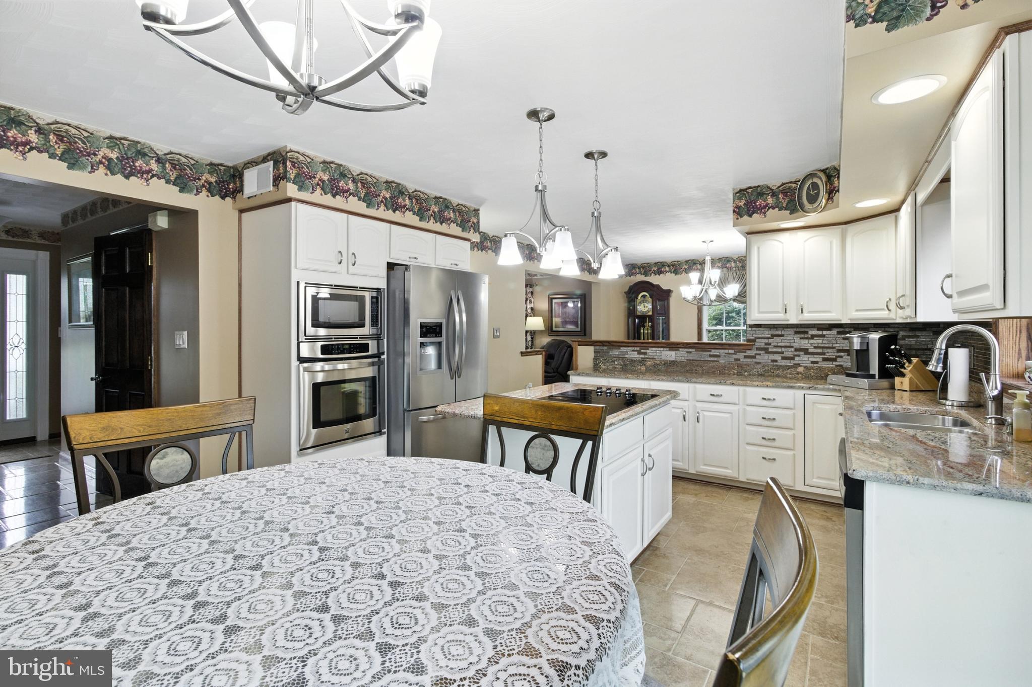 2230 Six Mile Road Philipsburg, PA 16866 - Photo 42 of 70 a kitchen with stainless steel appliances kitchen island granite countertop a sink refrigerator and cabinets