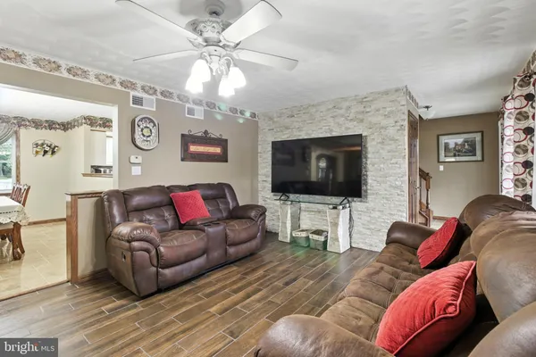 a living room with furniture and a floor to ceiling window