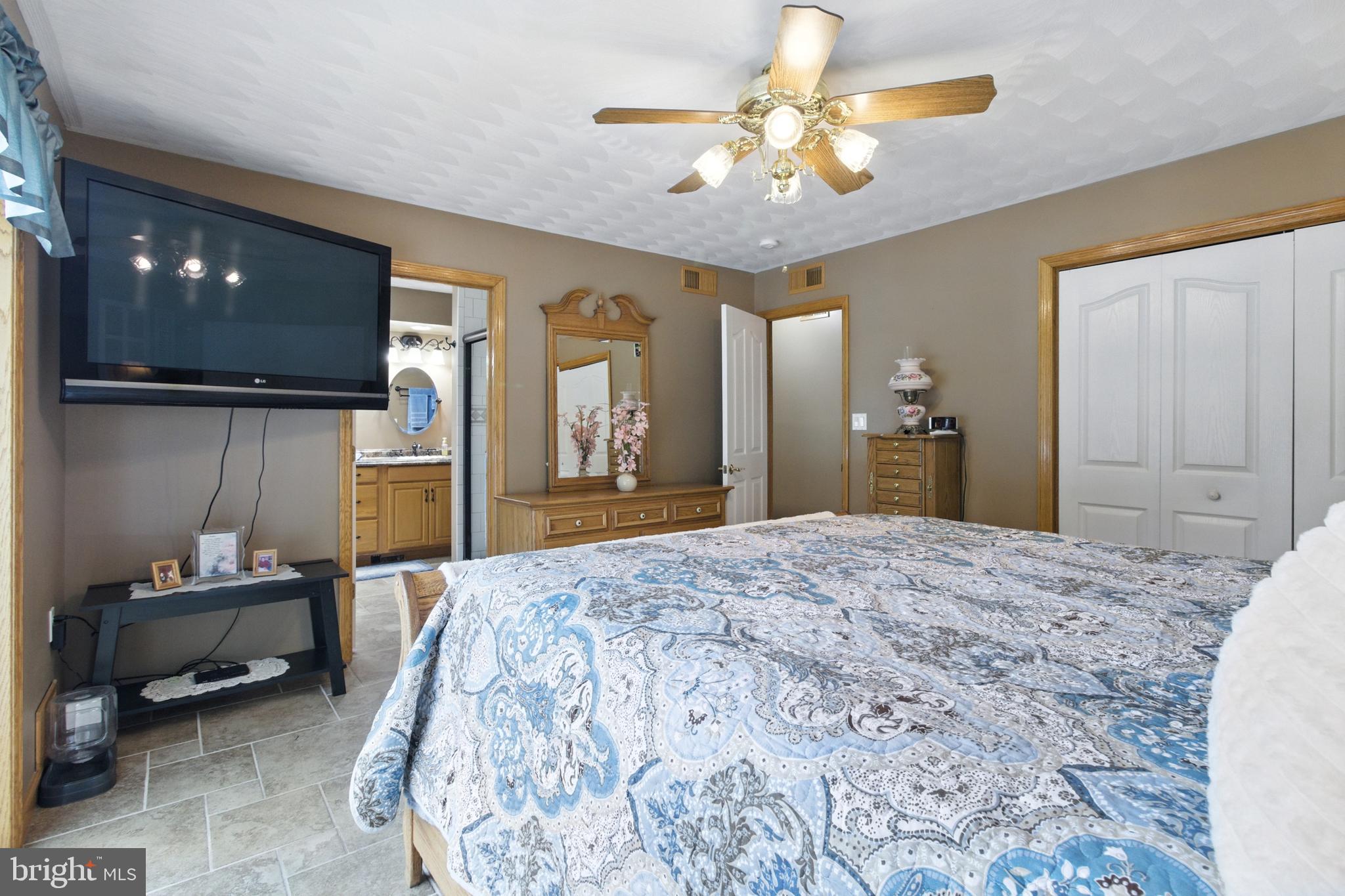 2230 Six Mile Road Philipsburg, PA 16866 - Photo 45 of 70 a spacious bedroom with a bed and a chandelier