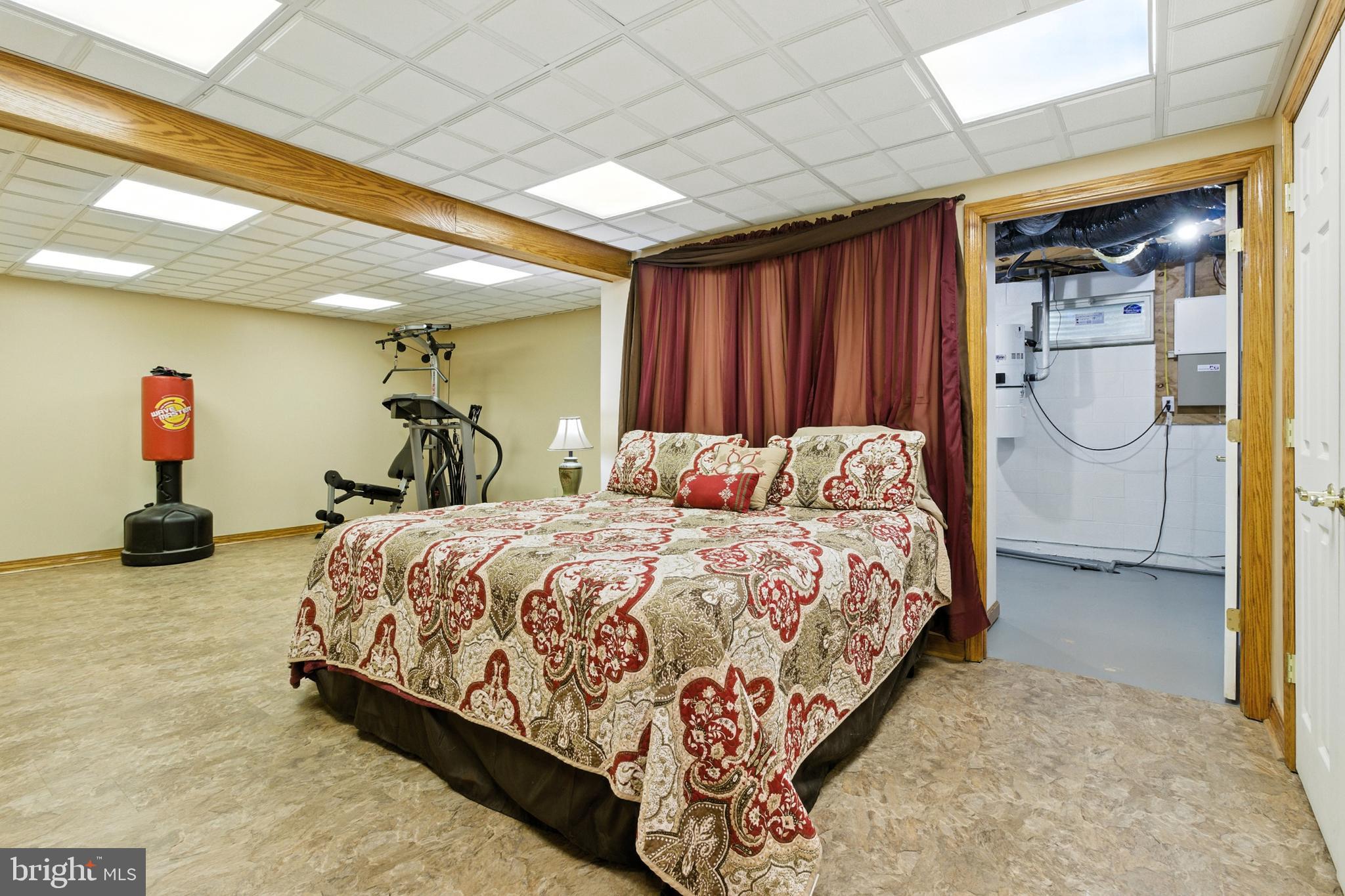 2230 Six Mile Road Philipsburg, PA 16866 - Photo 49 of 70 a bedroom with a bed and dresser with mirror