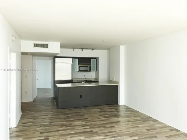 a view of kitchen with cabinets and wooden floor